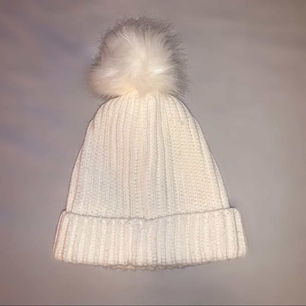 white beanie with a poof